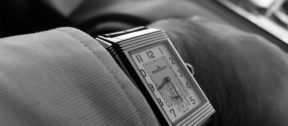 black and white photo of square faced watch