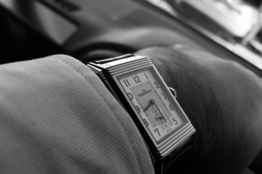black and white photo of square faced watch