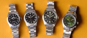 Selection of luxury watches on orange background