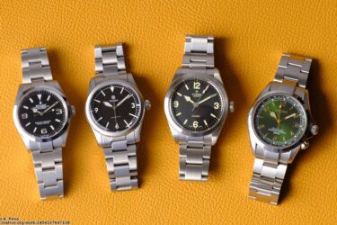 Selection of luxury watches on orange background