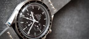 Close up of omega speedmaster moonwatch on grey material background