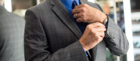 Man in Suit wearing a watch on his left hand